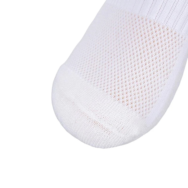 Close-up view of a white men's athletic soccer sock with a non-slip grip texture.