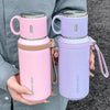 A pink and purple 316 stainless steel insulated water bottle is held in a person's hand.