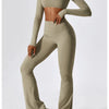 A woman models a beige women's performance tracksuit set consisting of a long-sleeved crop top and matching pants.