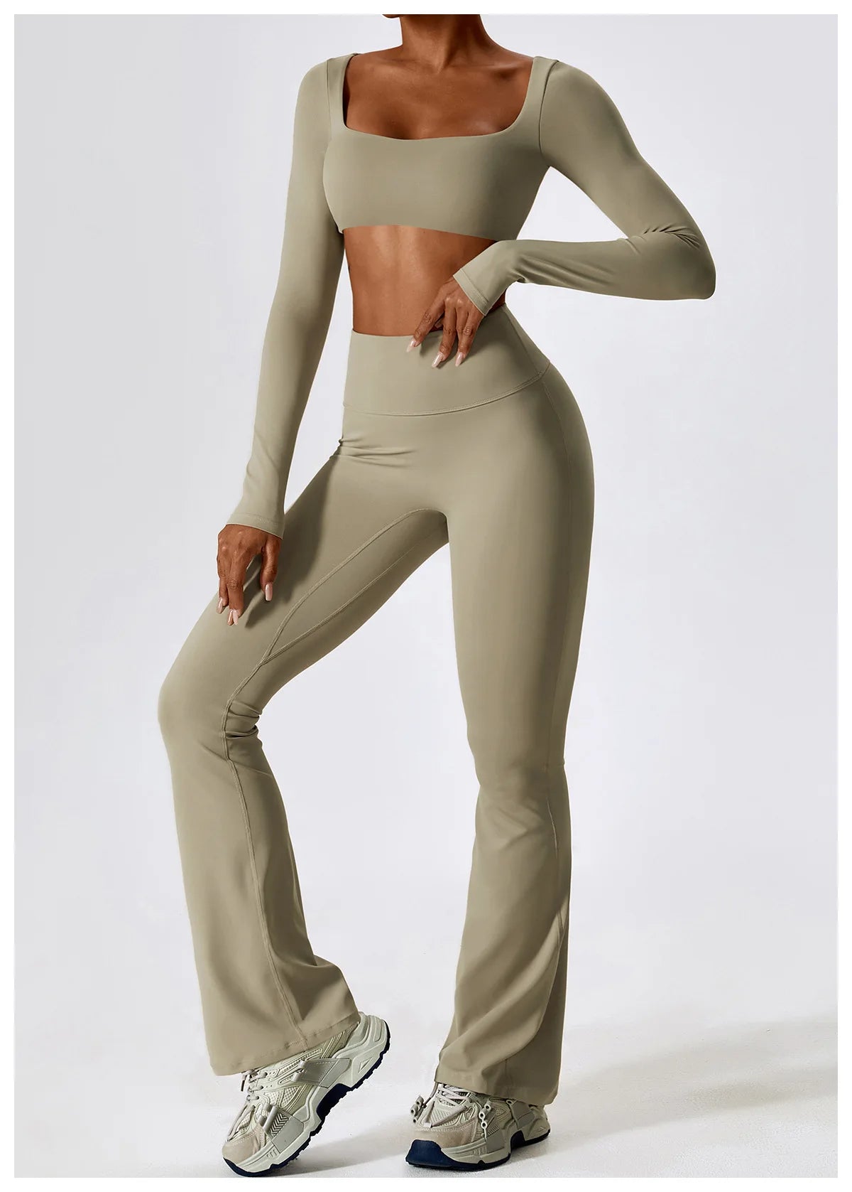 A woman models a beige women's performance tracksuit set consisting of a long-sleeved crop top and matching pants.