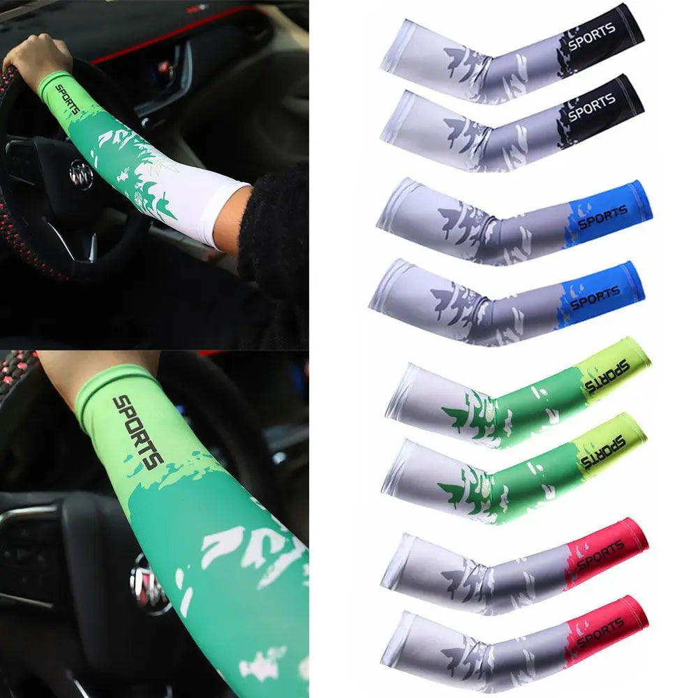 A set of two sports arm sleeves in green and silver with a leaf pattern shown on a person's arm.