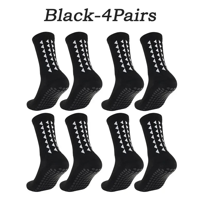A set of four pairs of black athletic grip socks.