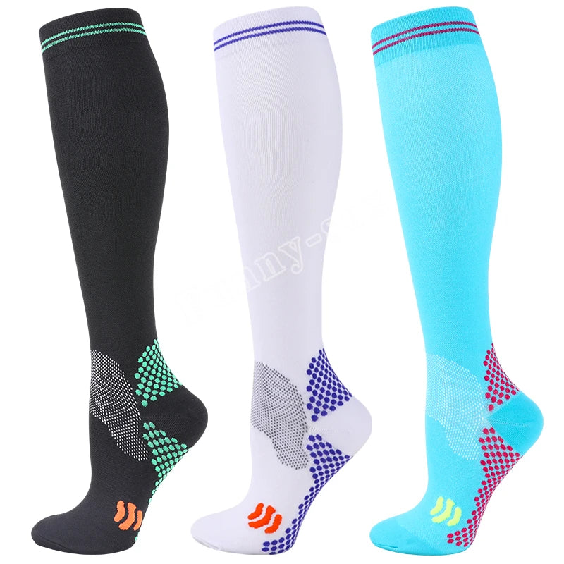 Three pairs of medical grade compression socks in black white and light blue colors