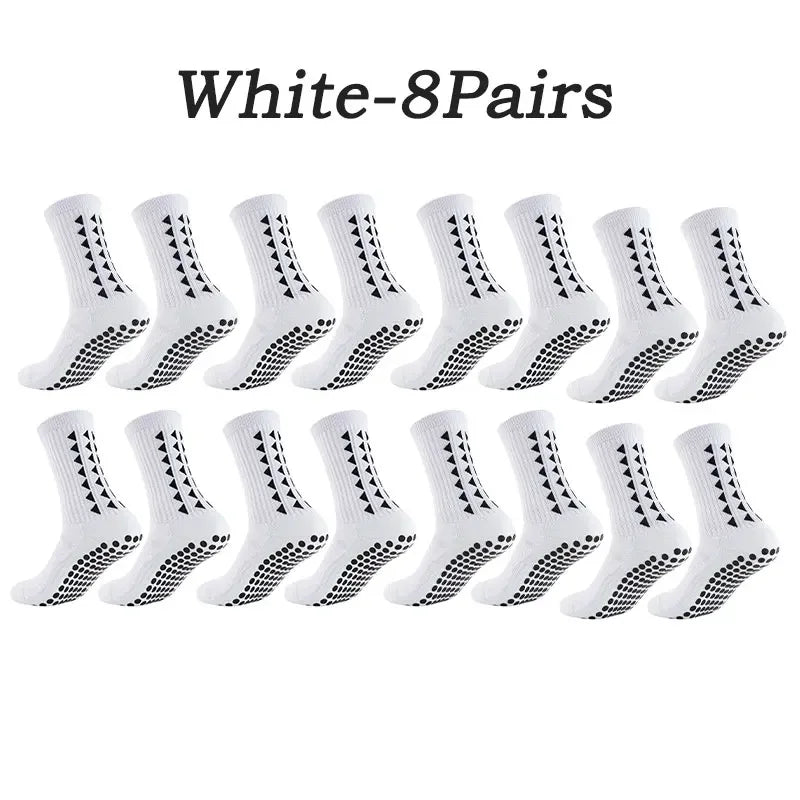 Eight pairs of white multi-sport athletic grip socks laid out for display.