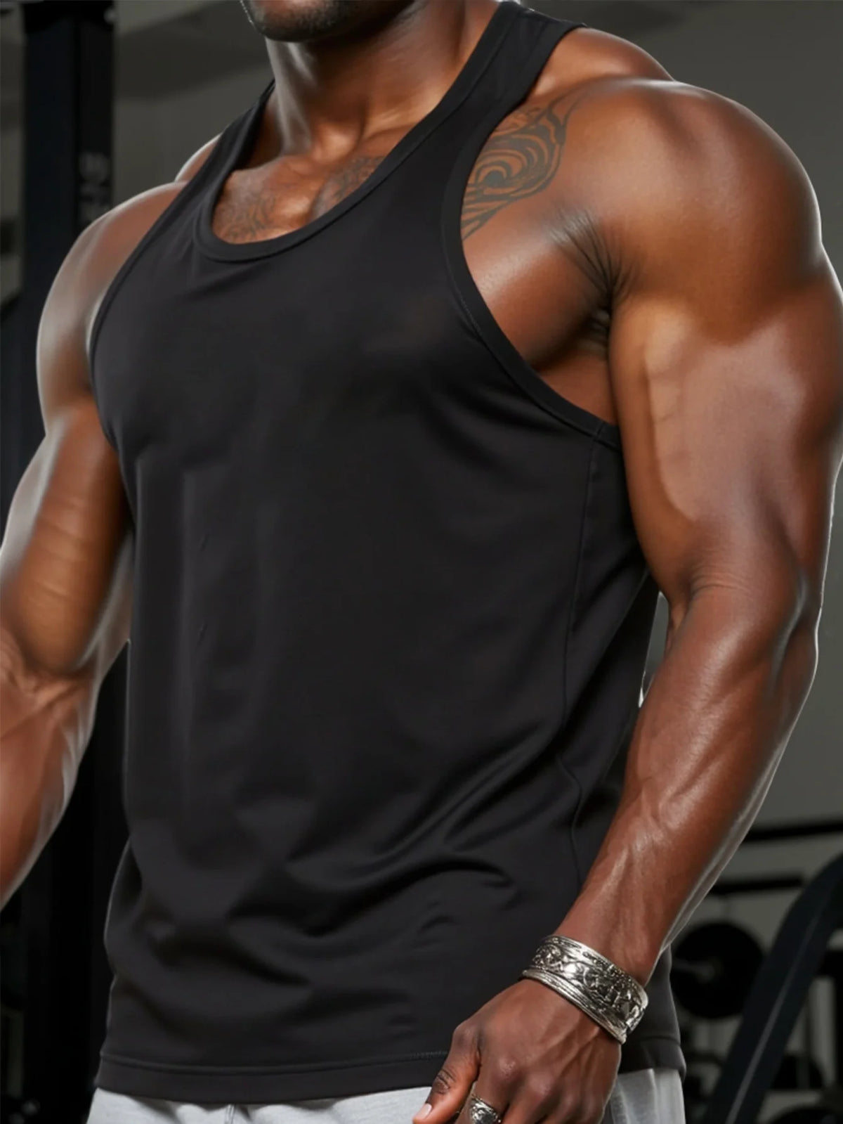 A muscular man wearing a black men's quick dry breathable sleeveless tank top.
