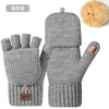 Gray knit gloves with a fluffy tan pom-pom and a brown tag
