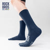 A close-up of a navy blue high elastic cycling and hiking sock worn on a leg.