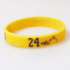 Yellow silicone wristband with the number 24 and a signature on the face