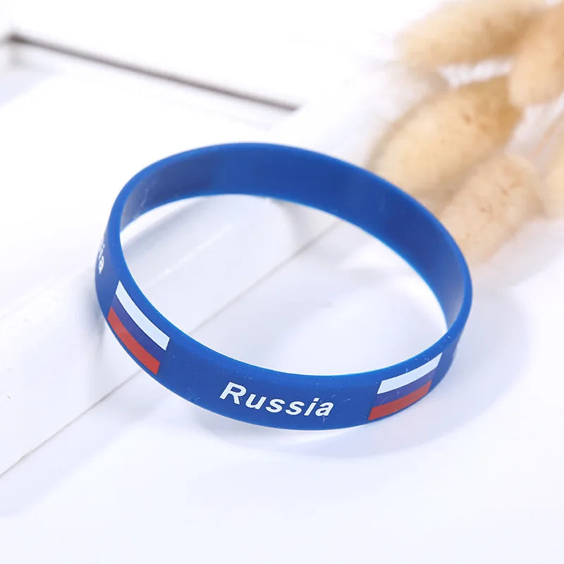 Blue silicone wristband with the flag of Russia on it, shown against a white background.