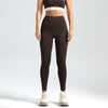A model wearing seamless high-waist yoga leggings and a matching crop top, standing against a light gray background.
