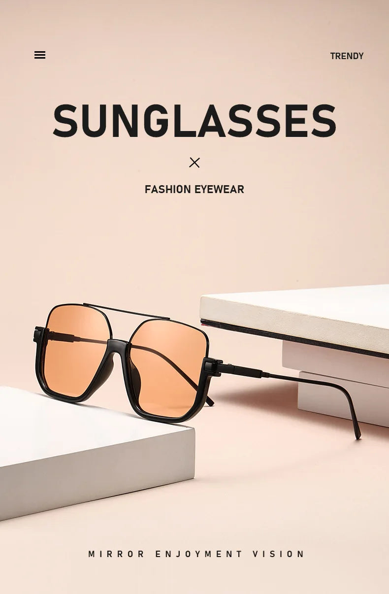 A pair of orange-tinted sunglasses with black frames resting on a white surface.