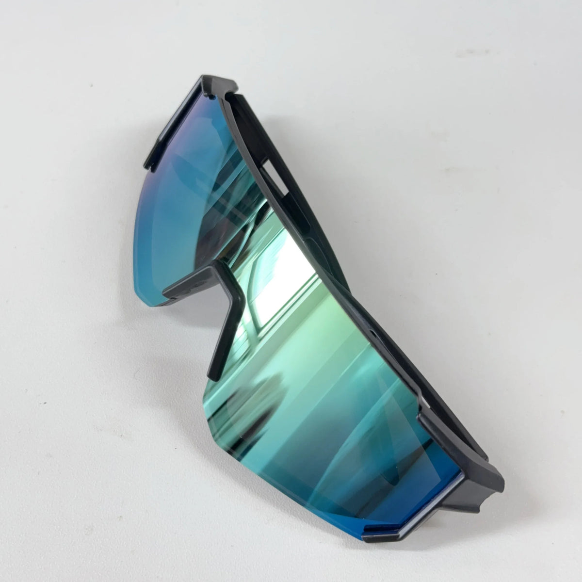 A pair of dark blue mirrored sports sunglasses with a black frame viewed from the side.