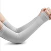 Gray compression arm sleeves worn on a person's legs and arms.