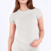 A woman wearing a light gray performance fitness short sleeve top.