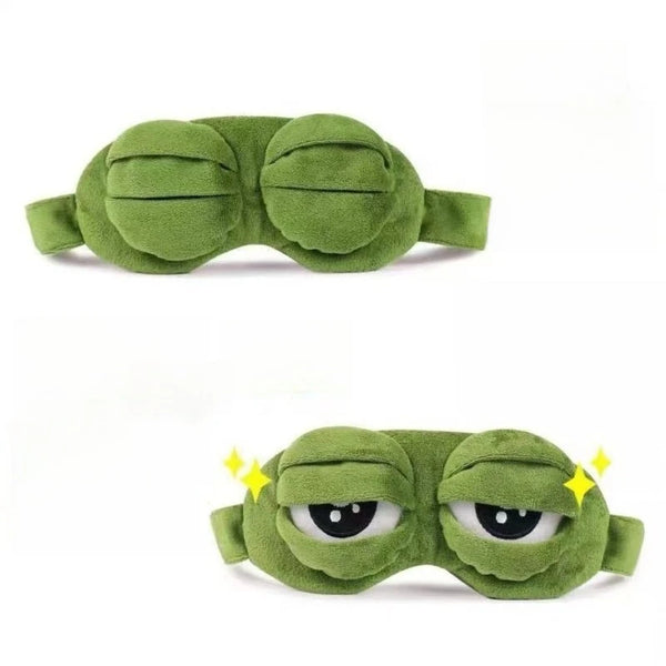 A green plush frog sleep eye mask with closed eyes.