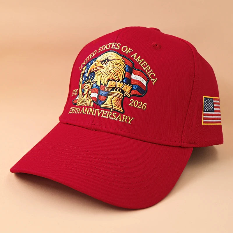 A red baseball cap featuring an embroidered design of an American eagle and text celebrating the 250th anniversary of the Uni