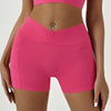 A model wears bright pink high-waisted yoga and fitness leggings.