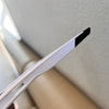A close-up view of black UV400 cycling sunglasses resting on a white strap.