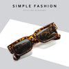 Brown leopard print sunglasses with tortoiseshell frames shown on a white background.