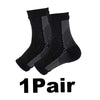 A pair of black compression ankle support braces shown flat.