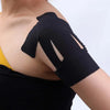 Black elastic patch applied to the shoulder area of a person's upper arm.