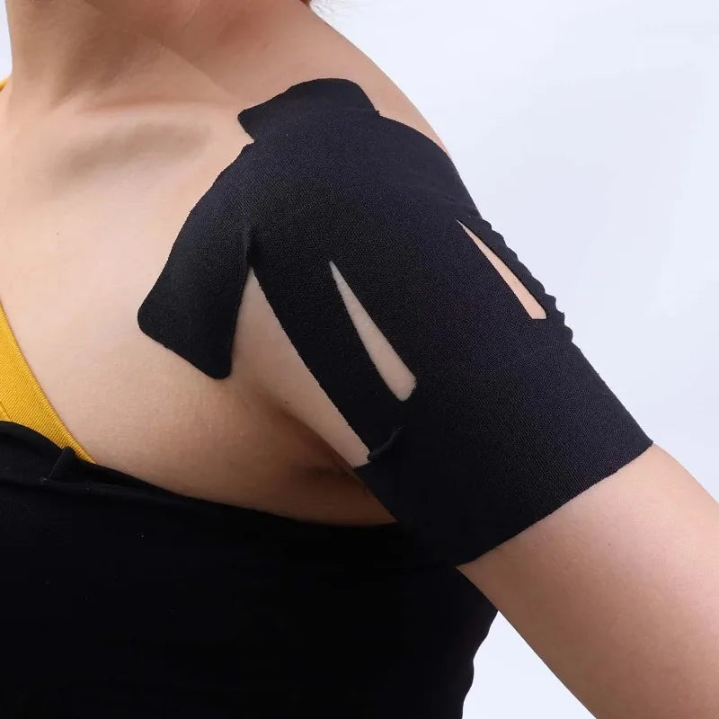 Black elastic patch applied to the shoulder area of a person's upper arm.