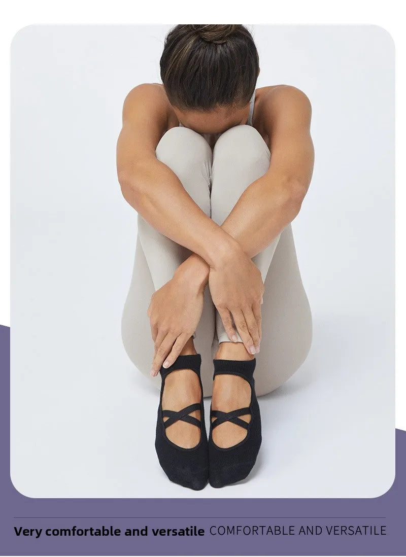 A person wearing black crisscross strap yoga socks is shown from the back.