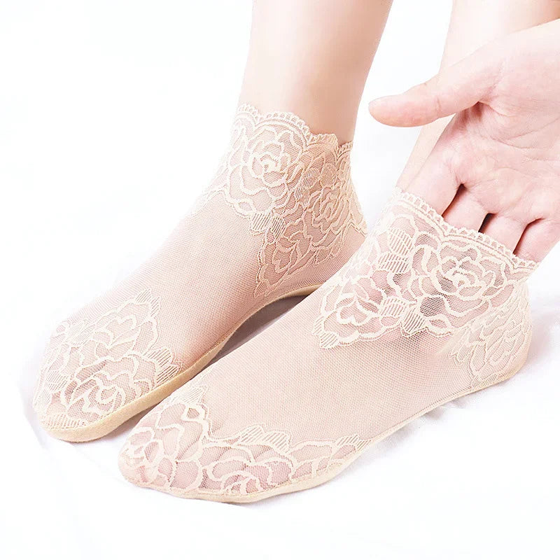 Pair of light pink lace mesh ankle socks displayed on a white background.