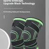 A pair of black and neon green compression knee braces displayed on a white stand.