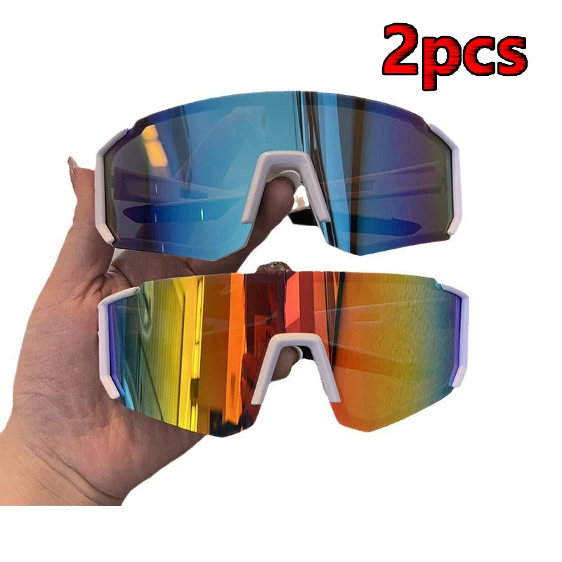 Two pairs of UV400 cycling sunglasses are shown being held in a hand.