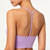 A woman wearing a lilac ribbed crop top sports bra for yoga and fitness, shown from the back.