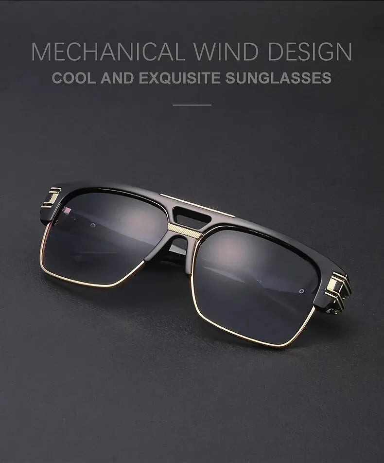 A pair of black and gold framed sunglasses with a square lens resting on a dark surface.