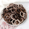A pile of 50 pieces of mixed color elastic hair bands in various shades of brown and beige.