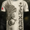 A white soccer jersey featuring a black eagle design and the word MEXICO printed on the front.