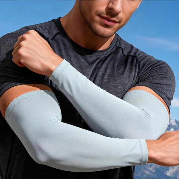 A man wearing a gray shirt shows off light blue sun protection knit sleeves on his forearm.