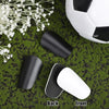 Black and white mini soccer shin guards shown with a soccer ball on green turf.