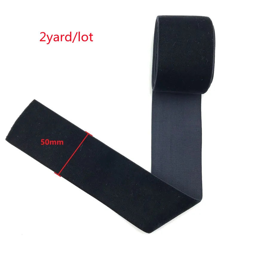 Black stretch velvet elastic headband shown flat and rolled, with a measurement line marked.