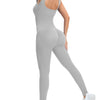 A model wearing a gray ribbed nylon bodycon jumpsuit with a high neck and long sleeves.