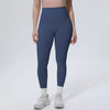 A model wearing dark blue high-waisted quick-drying yoga and fitness leggings with white socks and white athletic shoes.