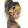 A close-up of a woman wearing a yellow floral butterfly patterned headband in her hair.