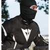 A man wearing a black mesh balaclava face mask while riding a motorcycle.