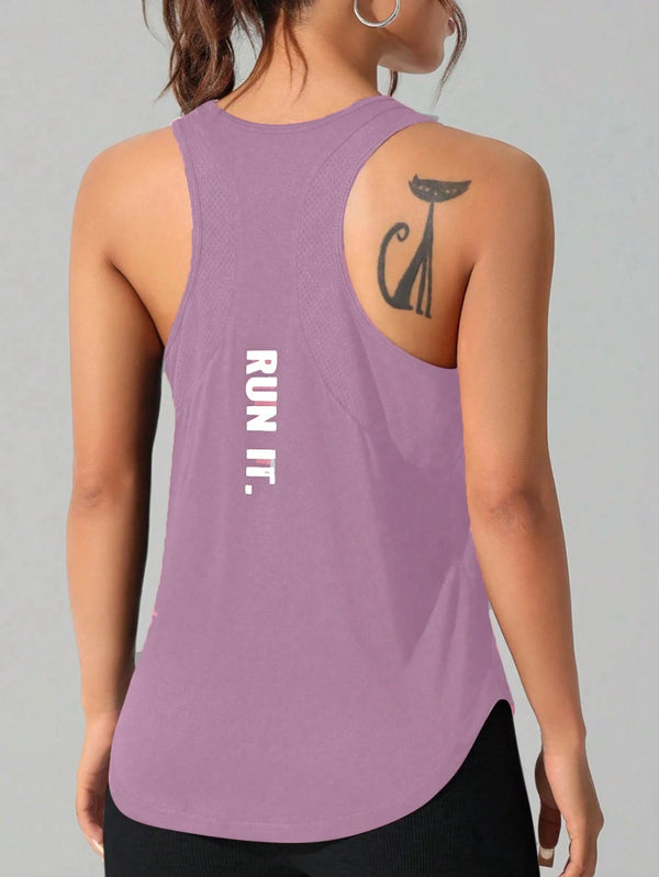 A woman wearing a purple running vest with a cat tattoo design on the shoulder.