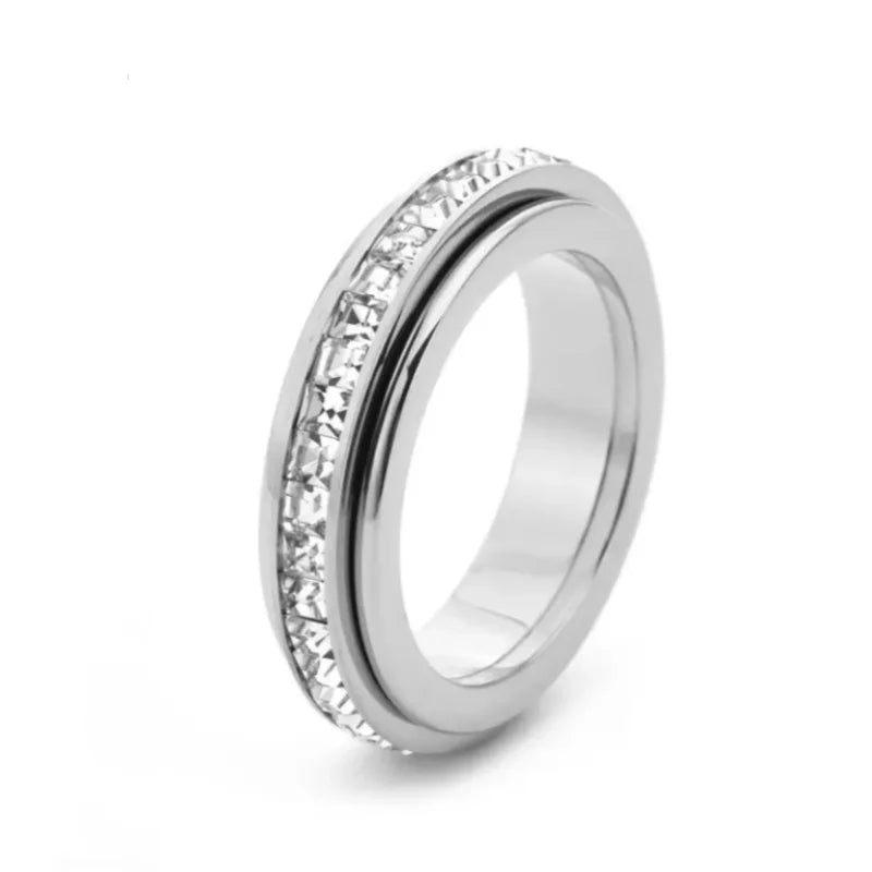 A close-up view of a silver stainless steel statement ring featuring a row of clear CZ gemstones.