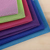 A stack of colorful microfiber cooling towels in various shades of purple, pink, green, and blue.