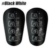 A pair of black white durable shin guards for soccer and football training.