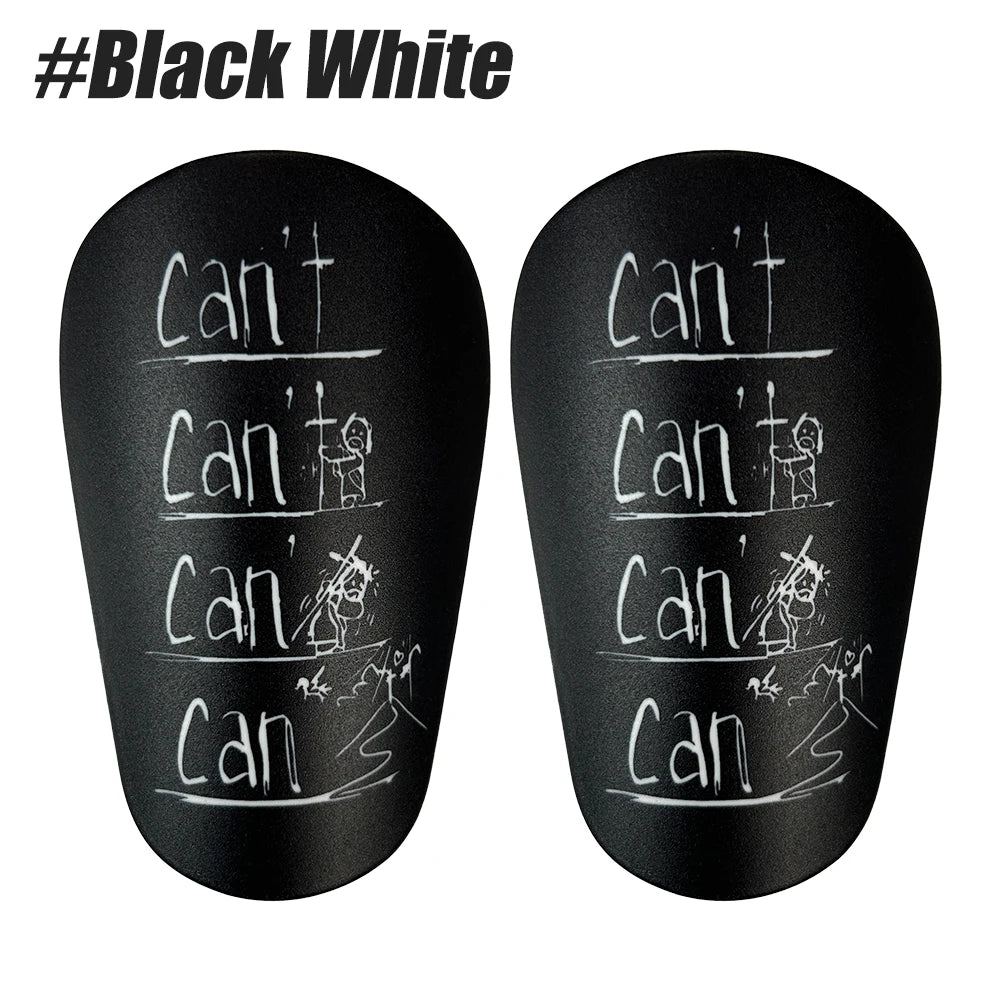 A pair of black white durable shin guards for soccer and football training.