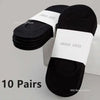 Ten pairs of black boat socks with white labels displayed on a white surface.