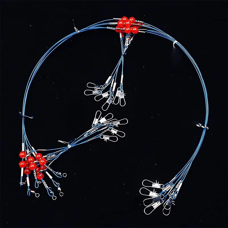 A multi-piece saltwater fishing tackle rig with red beads and wire lines is shown against a black background.
