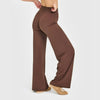 A model wearing brown high-waist yoga pants and tan shoes.