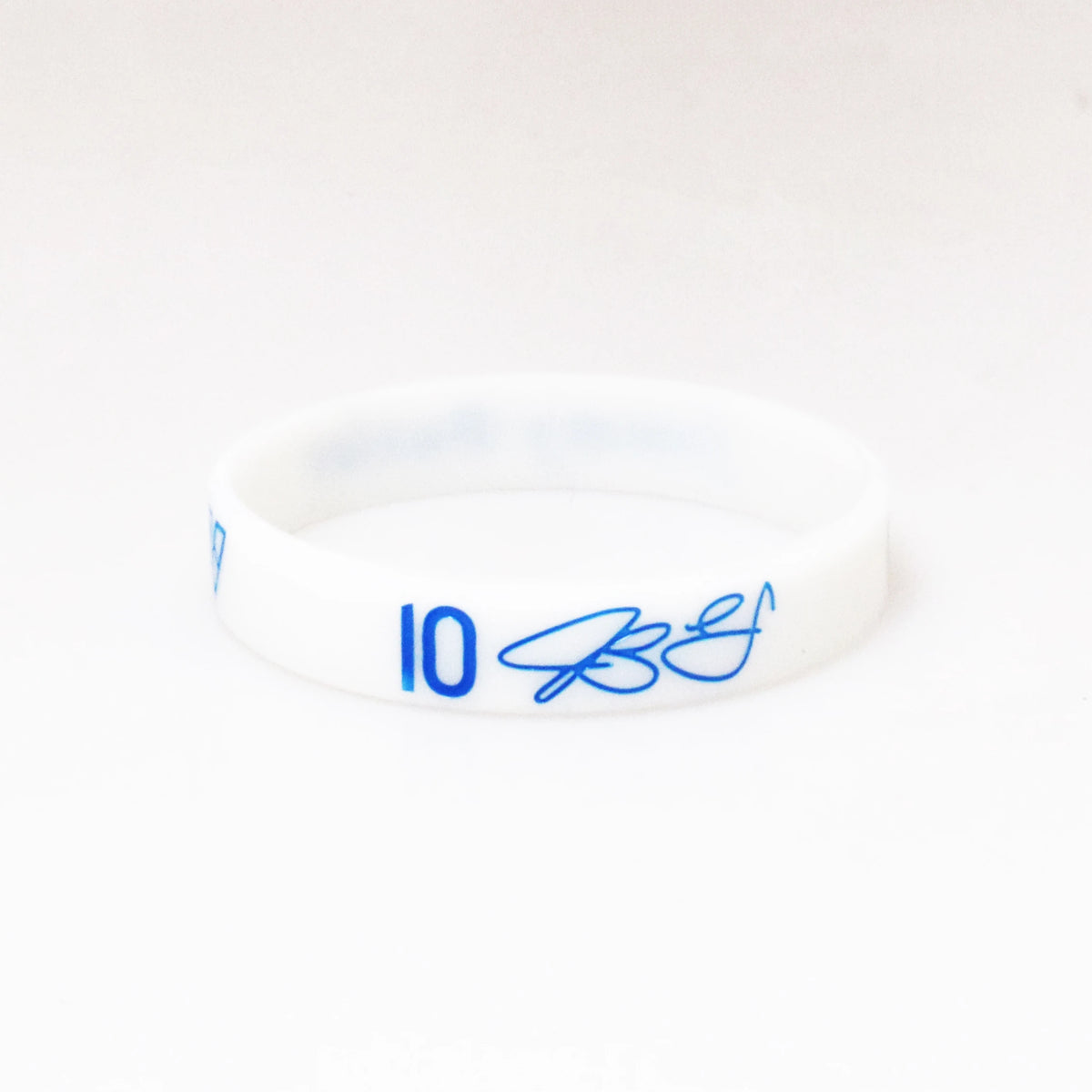 A white silicone wristband with the number 10 and a blue signature on the front.